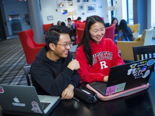 Two students looking at computer